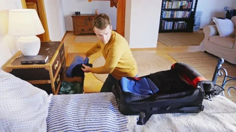 Man Packing Suitcase in a Hurry Running from War Man Ukraine Emmigration Stockbeeldmateriaal 195287859