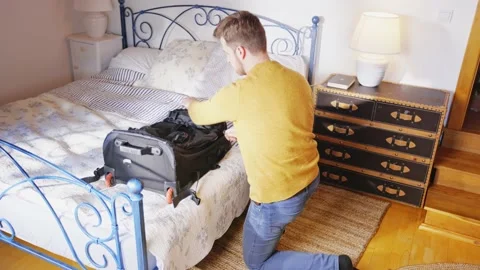 Man Packing Suitcase in a Hurry Running from War Man Ukraine Emmigration Stockbeeldmateriaal 195287960