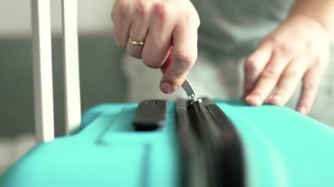 Man packing a suitcase for trip closeup. Travel concept slow motion. Stock Footage 301558332