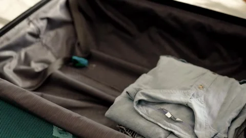 Man packing a suitcase for trip closeup. Travel concept slow motion. Stock Footage 301558638