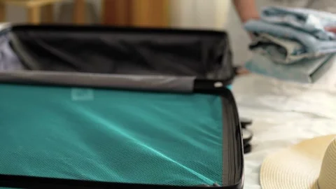 Man packing a suitcase for trip closeup. Travel concept slow motion. Stock Footage 301558656