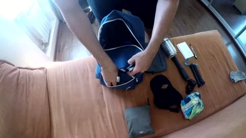 A man packs a backpack on a trip Stock Footage 161157448