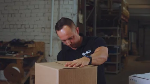 The man packs the goods, the packaging process Stock Footage 296348034