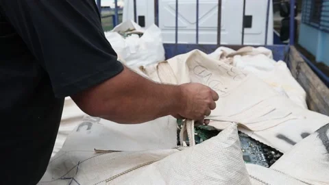 A man packs a large bag of obsolete computer components to be recycled Video stock 149793007
