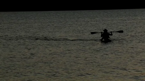 Man Padding a canoe on Paranoa Lake Stock Footage 115507961