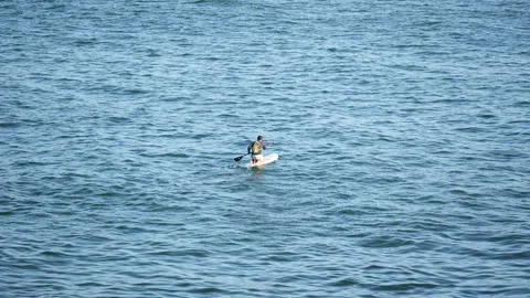 A man on a paddle board Vídeos de archivo 311608854