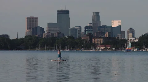 Man on Paddle Board on Lake Calhoun with Minneapolis in Background Stock Footage