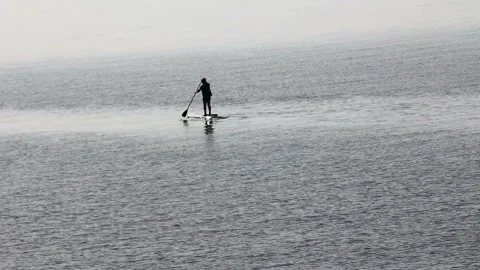 Man with a paddle on the water surface Stock Footage 99824180