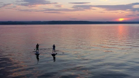 A Man On A Paddleboard Touring On The River Against The Beautifull Sunset Stock Footage 112698841