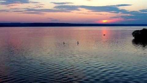 A Man On A Paddleboard Touring On The River Against The Beautifull Sunset Stock Footage 112700505