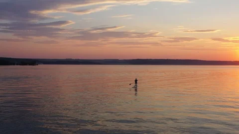 A Man On A Paddleboard Touring On The River Against The Beautifull Sunset Stock Footage 115828647