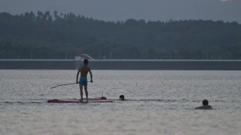 Man Paddleboarding Alone on Reservoir Stock-Footage 345040676