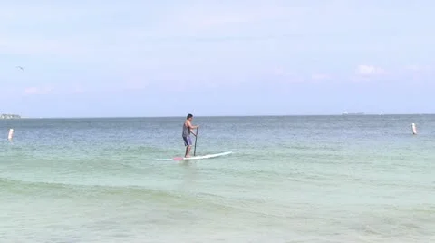 Man paddleboarding Stock Footage 12114803