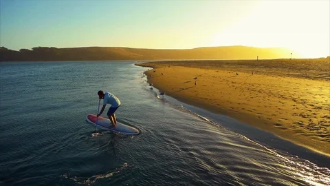 Man paddleboarding in the shallows. Stock Footage 88368290