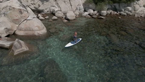 Man paddles on the board in relaxing state Stock Footage 163686347