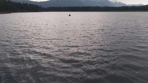 Man Paddles canoe through pristine mountain lake in the Cascades of Washington 스톡 동영상 111393738