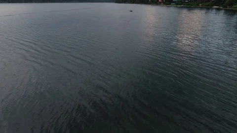 Man Paddles canoe through pristine mountain lake in the Cascades of Washington Stock Footage 111394302