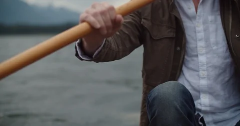Man Paddles canoe through pristine mountain lake in the Cascades of Washington Stock Footage 111396633