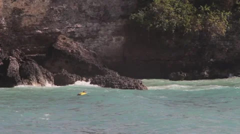 Man Paddles on a Surfboard Stock Footage 67532601