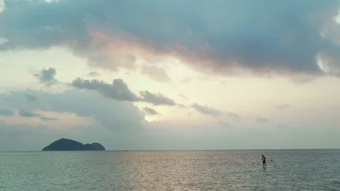 Man Paddling at Beautiful Sunset Stock Footage 153523532
