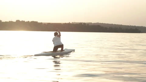 Man paddling a canoe on river Stock Footage 135864775