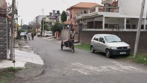 Man paddling hard to push man powered trolley in a residential area Stock Footage 147628081