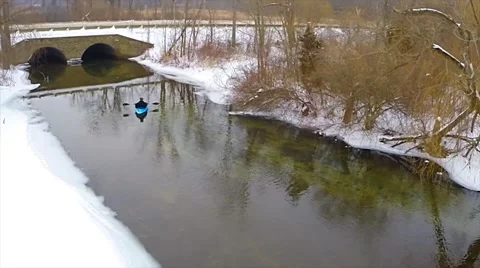 Man paddling kayak down river on a cold winters day Stock Footage 47975852