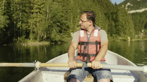 Man Is Paddling On The Small Boat In Middle Of The Lake.  Stock Footage 162691853