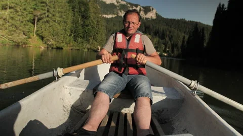 Man Is Paddling On The Small Boat In Middle Of The Lake.  Stock-Footage 162697341