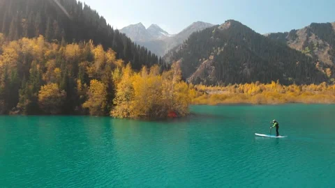 Man is paddling on Sup board in the mountain lake Stock Footage 141056434