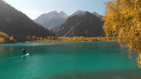 Man is paddling on Sup board in the mountain lake Stock Footage 141056891