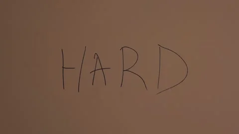 Man paint a writing on the wall "Hard" concept of bad problem solving Vidéo 134354689