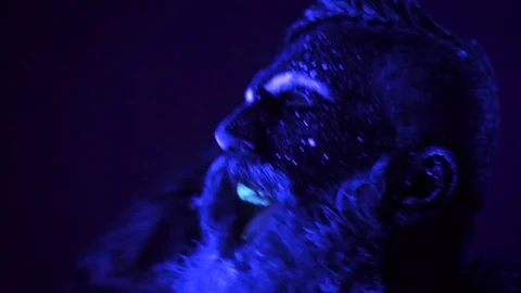 Man painted fluorescent powder dance in ultraviolet light Stock Footage 81208028