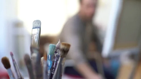 Man painting on canvas in studio Stock Footage 75200124