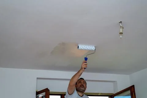 Man painting a ceiling Stock Photos