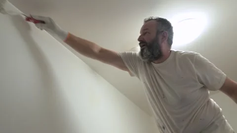 Man painting ceiling with roller — home interior renovation, horizontal 4K Stock Footage 319034057