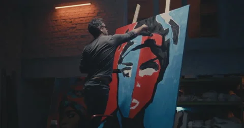 Man painting creative portrait in studio Stock Footage 144791626