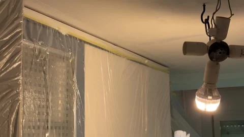 Man painting the edge of a ceiling with a brush 動画素材 341363368
