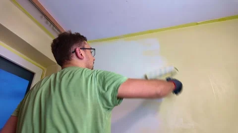 Man painting interior wall with roller in living room, timelapse Stock Footage 335315003