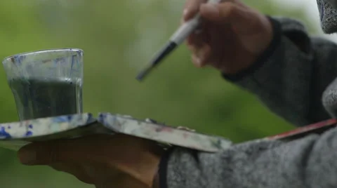 Man painting in the park Stock Footage
