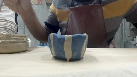 Man painting pottery Stock Footage 100717346