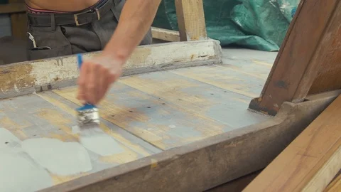 Man painting sanded teak deck planking with aluminium based wood primer 스톡 동영상 108393693