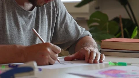Man painting sitting at the table. Stock Footage 252857319