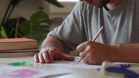 Man painting sitting at the table. Stock Footage 252857546