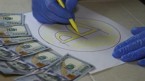 A man  paints bitcoin with markers. Stock Footage 145142749