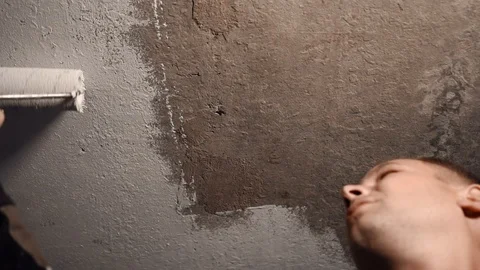 Man paints the ceiling with a roller Stock Footage 116433521