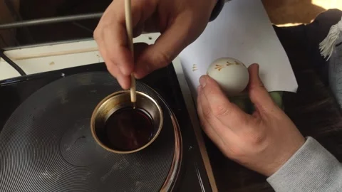 A man paints an Easter egg Stock Footage 172146730
