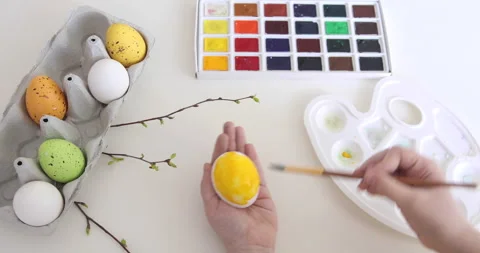 Man paints Easter eggs. Preparing for Easter. Multi-colored eggs. Easter eggs. Stock Footage 151990528