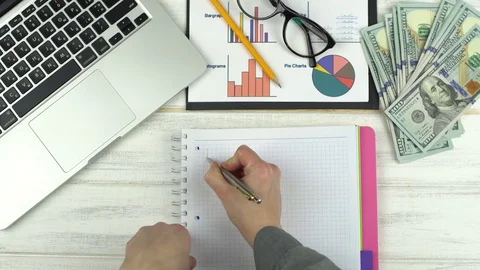Man paints a graph in notebook Stock-Footage 73456538