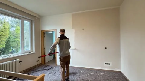 Man paints interior room white in time lapse refreshing the walls for a clean Stock Footage 323381611